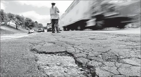  ?? Mark Boster Los Angeles Times ?? BY SOME estimates, the cost of California’s deferred road maintenanc­e is $130 billion. New taxes are expected to yield $5.2 billion a year.