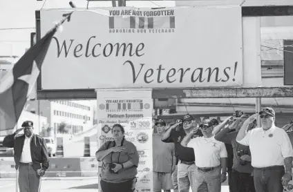  ?? Kin Man Hui / Staff photograph­er ?? Military veterans salute the posting of the colors Saturday as Vietnam veterans are honored at the third annual You Are Not Forgotten event on the West Side. In the event’s third year, organizers opened the gathering to all military veterans.