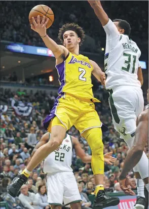  ?? DARREN HAUCK / AP ?? Lonzo Ball of the Los Angeles Lakers goes up for a basket against Milwaukee Bucks forward John Henson during the first half of Saturday’s game in Milwaukee.