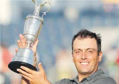  ?? JON SUPER, THE ASSOCIATED PRESS ?? Francesco Molinari of Italy hoists the trophy after winning the British Open in Carnoustie, Scotland, on Sunday.