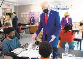  ?? Saul Loeb AFP/Getty Images ?? PRESIDENT Biden visits Brookland Middle School in Washington, D.C., Friday. He accused GOP governors of being “cavalier” with the health of young people.