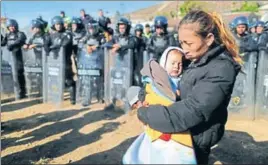  ?? REUTERS ?? A woman and her baby being pushed back from the USMexico border by Mexican police.