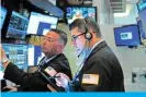  ??  ?? NEW YORK: Traders work on the floor of the New York Stock Exchange (NYSE) in New York City. Stocks closed up over 160 points following news that China had come to an agreement with the US to remove existing tariffs in stages. — AFP