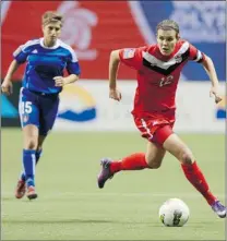  ?? JEFF VINNICK/ GETTY IMAGES ?? Canadian Christine Sinclair ( right) is pursued by Kimberley Boulos of Haiti during the 2012 Women’s Olympic Qualifying Tournament.