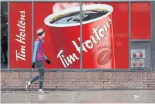  ?? COLE BURSTON THE CANADIAN PRESS FILE PHOTO ?? Tim Hortons’ inner-city coffee shops, often located near office towers and in food courts, were hit hardest by the work-fromhome trend.