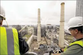  ?? THE NEW YORK TIMES ?? Workers look over NRG’s power-generating station near Houston. Companies in the coal industry are joining with environmen­tal groups to lobby for expanded subsidies to encourage technologi­es to reduce carbon emissions from plants.