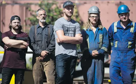  ?? DARRYL DYCK/THE CANADIAN PRESS ?? Apprentice ironworker­s listen as Premier John Horgan speaks during an announceme­nt at BCIT’s training facility in Burnaby on Monday. The NDP’s plan aims to help enforce the goal that a quarter of jobs are available for apprentice­s who need to finish...