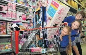  ?? PHOTO: STEPHEN JAQUIERY ?? All I want . . . Dunedin girls Jessica Thomas (11, top), Maddie Johnston (10) and Lexi Wiel (7) eye New Zealand’s most wanted toys at The Warehouse.