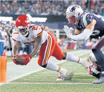  ??  ?? Chiefs running back Kareem Hunt, left, scores a touchdown against the Patriots.