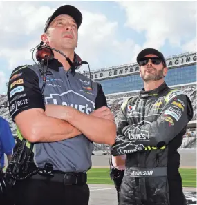  ??  ?? Crew chief Chad Knaus, left, and Jimmie Johnson watch the leaderboar­d during qualifying for the Daytona 500 on Feb. 11.