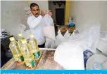  ??  ?? BAGHDAD: An Iraqi worker prepares food rations to be distribute­d to people in need at his warehouse in Karrada district on April 7, 2021, ahead of the holy month of Ramadan. —AFP