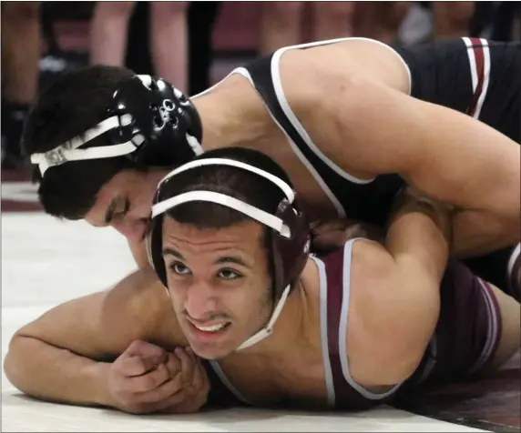  ?? JULIA MALAKIE — LOWELL SUN ?? Chelmsford’s Manny Marshall, top, won on points vs. Lowell’s Hussain Alobaidi in a 152-pound wrestling match Wednesday night at Chelmsford High. Chelmsford was a 49-19 winner.