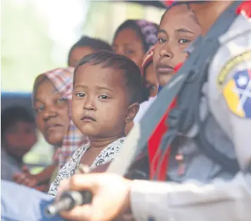  ?? EPA-EFE ?? Malaysia-bound Rohingya refugees sit in a Myanmar police truck that will carry the group back to Sittwe, Rakhine state.