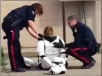 ??  ?? In this screen grab from a video posted by YouTube user Deiby Corleoni, Lethbridge police officers attend to a woman in a stormtroop­er costume Monday in front of a northside restaurant.