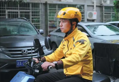  ?? PROVIDED TO CHINA DAILY ?? Meituan deliveryma­n Yao Zhigang rides a motorbike to work in Changsha, Hunan province.