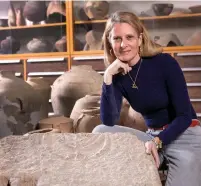  ?? (Tal Rogovsky) ?? DR. KATIA CYTRYN-SILVERMAN poses with the recently discovered basalt stone decorated with a menorah.