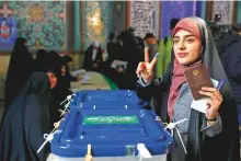 ?? AP ?? A voter flashes a victory sign with her inked finger at a polling station in Tehran on Friday.