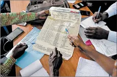  ?? JEROME DELAY/AP ?? Officials tally presidenti­al ballots Friday in Kinshasa, Congo, where the first results are expected Sunday.