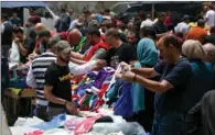  ?? (AFP) ?? Palestinia­ns gather at a market in the West Bank city of Ramallah, after the authoritie­s relaxed some COVID-19 measures.