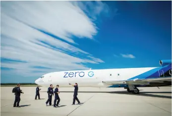  ?? PHOTO BY STEVE BOXALL COURTESY OF THE ZERO GRAVITY CORP. ?? Passengers assemble on the runway before boarding the Boeing 727 owned by Zero Gravity Corp., based in Arlington, Va.