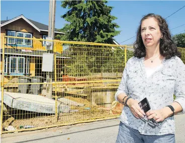 ?? — GERRY KAHRMANN ?? Roanna Zuker in the alley behind the house under constructi­on at 2560 Trinity that resulted in the removal of a 65-year-old Douglas fir tree. She has signed a petition and is questionin­g why the heritage tree was taken down.