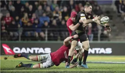  ??  ?? HAMILTON: Chiefs captain Stephen Donald passes the ball as he is tackled by British & Irish Lions players at Waikato Stadium in Hamilton, New Zealand, yesterday.— AP