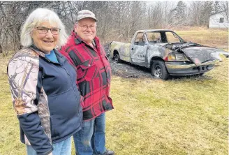  ?? CARLA ALLEN ?? Bernise and Arnold Ellis stand by what’s left of their truck after a fire on March 16.