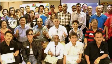  ??  ?? Big day: John (seated third from left) and his volunteers at a graduation ceremony for the inmates in Kuala Lumpur.