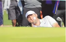  ?? MICHAEL WYKE / ASSOCIATED PRESS ?? Scottie Scheffler hits out of the bunker on the 18th green Thursday during the first round of the Houston Open.