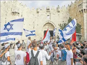  ?? Picture: REUTERS ?? Israelis with flags near Damascus Gate, the entrance to Jerusalem’s Old City.