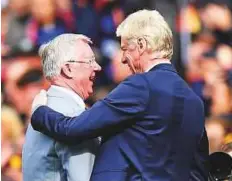  ?? AFP ?? Arsene Wenger (right) is greeted by former United manager Alex Ferguson during a presentati­on at Old Trafford yesterday.