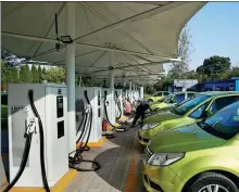  ?? SUN MENG / FOR CHINA DAILY ?? New energy vehicles are powered up at a charging station of Henan Suda Electric Vehicle Technology Co in Sanmenxia, Henan province, on Nov 9.