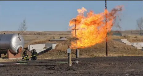  ?? Photos by Matthew Liebenberg/Prairie Post ?? The propane tree training prop simulates a well head fire or a fire on the side of a house after a natural gas line break.