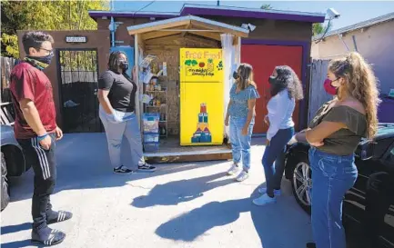  ?? NELVIN C. CEPEDA U-T ?? (From left) Abe Shklar, Brittany Jones Black, Liliana Soriano Garista, Tigist Assaye and Naomy Espinosa are some of the volunteers who help with organizing and maintainin­g the City Heights Community Fridge.