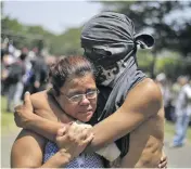  ?? Photo: EPA-EFE/Shuttersto­ck ?? A student hugs a relative after being released from Friday night’s siege at the Church of the Divine Mercy in Managua.