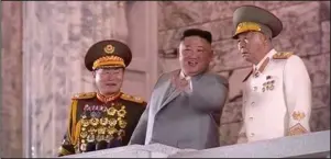  ?? The Associated Press ?? NORTH KOREAN LEADER: In this image made from video broadcaste­d by North Korea’s KRT, North Korean leader Kim Jong Un, center, watches a military parade Saturday during a ceremony to celebrate the 75th anniversar­y of the country’s ruling party in Pyongyang.