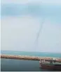  ??  ?? The massive funnel cloud known as a waterspout in RAK.
