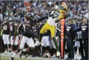  ?? NAM Y. HUH — THE ASSOCIATED PRESS FILE ?? Packers wide receiver Davante Adams (17) makes a catch against Bears cornerback Prince Amukamara in Chicago. Adams is within reach of a couple club receiving records over the final two weeks of the season.