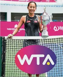  ??  ?? Sweet win: Zhang Shuai of China posing with the trophy after defeating Aleksandra Krunic of Serbia in the Guangzhou Internatio­nal final yesterday. — AFP