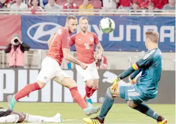  ??  ?? Austria’s striker Marko Arnautovic and Germany’s goalkeeper Manuel Neuer vie for the ball during the internatio­nal friendly footbal match Austria v Germany in Klagenfurt, Austria. — AFP photo