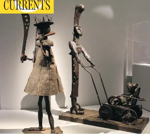  ?? THE WASHINGTON POST ?? The iron warrior made by Dahomey sculptor Akpele Kendo Akati, left, stands next to Pablo Picasso’s Femme à la Poussette in Paris.