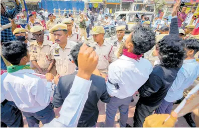  ?? AP ?? Policemen stand guard as students protest against the Citizenshi­p Amendment Act in Guwahati, India, yesterday.