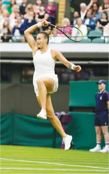  ?? Associated Press ?? Aryna Sabalenka returns a ball to Monica Niculescu during their first round of Wimbledon in London on Monday.