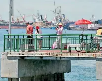  ??  ?? Singapore is now aspiring to increase its food self-sufficienc­y from less than 10 percent (2019) to 30 percent by 2030. Fisheries and aquacultur­e is tipped to become one of the main contributo­rs in maintainin­g food security of the country. Picture shows people fishing on a jetty at the Eastern Anchorage area in Singapore (AFP)