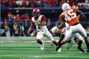  ?? The Associated Press ?? PLAYER OF THE YEAR: Oklahoma Sooners quarterbac­k Kyler Murray (1) looks for room to run against the Texas Longhorns during the first half of the NCAA Big 12 Conference championsh­ip Saturday in Arlington, Texas. Murray was named The Associated Press college football Player of the Year Thursday.
