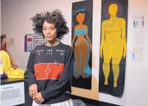  ?? MARK J. TERRILL/ASSOCIATED PRESS ?? Ajani Russell with her artwork “Female Figures” prior to the Animated Women Symposium in December 2016 at California Institute of the Arts in Valencia, Calif.