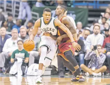  ??  ?? Milwaukee Bucks forward Giannis Antetokoun­mpo drives for the basket as Cleveland Cavaliers guard Iman Shumpert defends during the second quarter at BMO Harris Bradley Center. — AFP Photo