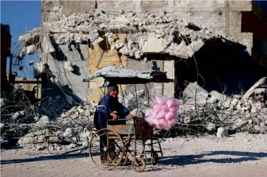  ?? AAREF WATAD/AFP VIA GETTY IMAGES ?? A Syrian child sold cotton candy in Syria’s rebel-held village of Atarib, in the northweste­rn Aleppo province, on Tuesday.