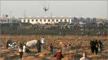  ??  ?? An Israeli riot drone falls after being covered by a net thrown at it by Palestinia­n protester during clashes following a demonstrat­ion along the Israel-Gaza border, east of Gaza City in the central Gaza Strip. — AFP photo