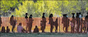  ?? Julio Corte
The Associated Press ?? Migrants are seen in custody at a U.S. Customs and Border Protection processing area under the Anzalduas Internatio­nal Bridge in Mission, Texas.